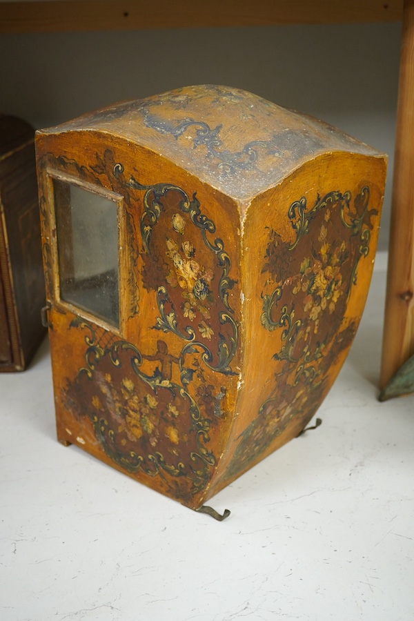 A Venetian painted wooden model of a sedan chair, probably designed for a doll, 36cm high. Condition - some crazing to the painted cartouche decoration, gilt worn, One glass panel missing